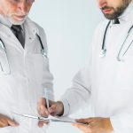A physician conducts a clinical assessment of a patient suffering from erectile dysfunction as part of a specialized medical approach.